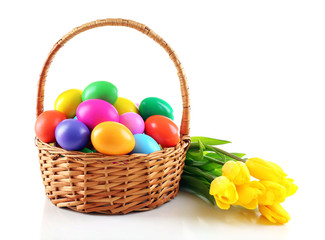 Multicoloured Easter eggs in basket isolated on white