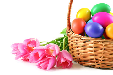 Multicoloured Easter eggs in basket isolated on white