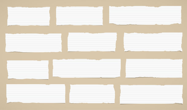 Pieces Of Torn White Lined Note Paper Sticked On Brown Wall