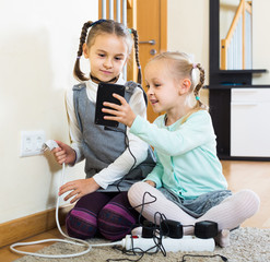 children playing with sockets and electricity indoors