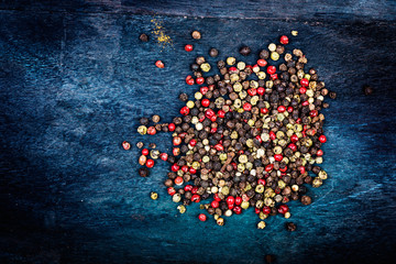 mixture of peppers on wooden background.