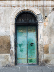 Fototapeta na wymiar Door of an old building with rusty and peeling paint