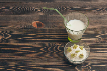 Glass of milk cocktail with kiwi fruits and mousse