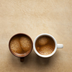 Two espresso cup on brown table