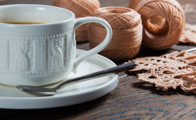 Fototapeta na wymiar beautiful yarn for knitting Irish lace with black coffee