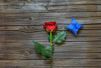 Single red rose with a Valentines gift