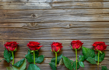 Border of fresh red roses and a Valentines gift