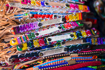 Fototapeta na wymiar Numerous wristbands with Guatemala sing at the craft market 