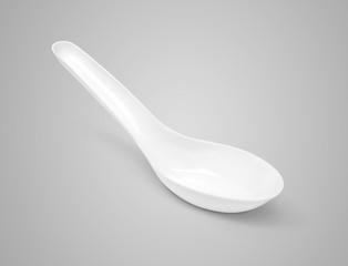 plastic spoon isolated on gray background