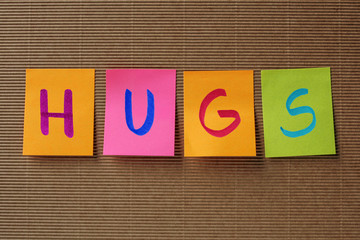 hugs text on colorful sticky notes