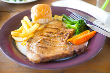 grilled pork with garlic sauce and french fries