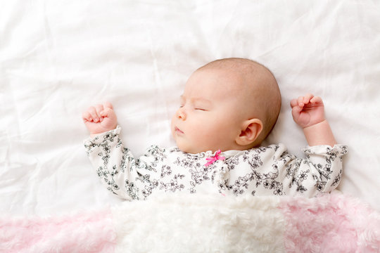 Newborn baby girl on her blanket