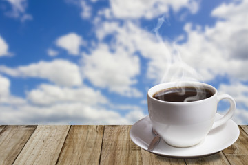Morning coffee cup with beautiful blue sky and puffy clouds back