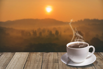 cup of coffee with mountain at morning sunrise.