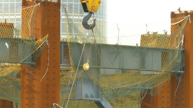 Tower crane close-up on lifting hook, zoom out