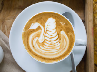 Top view of coffee with latte art in swan shape, background conc