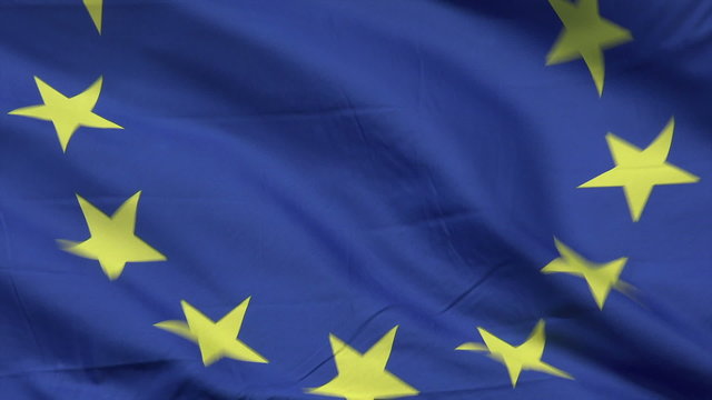 EU flag blowing in wind with blue sky background, European Union