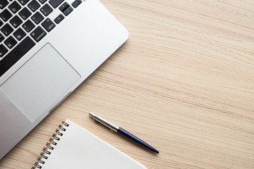 office table with laptop, notebook and camera film. Top view wit