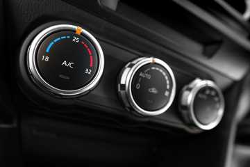 detail of the air conditioning button inside a car