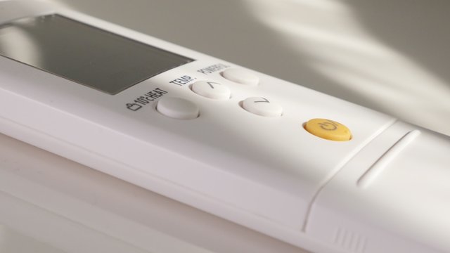 Temperature set on air conditioner remote control 4K 3840X2160 UltraHD footage - Lowering down room temperature on air-con remote 4K 2160p UHD video 