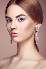 Fototapeta premium Fashion portrait of young beautiful woman with jewelry. Brunette girl. Perfect make-up. Beauty style woman with diamond accessories