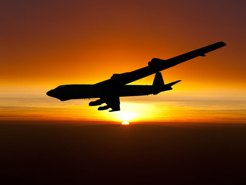 Vietnam War Era jet bomber B-52 banking right at sunset. (Artist's impression)