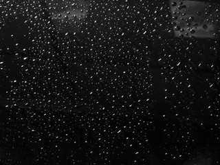 Water drops on black glass texture