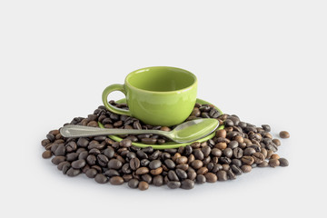 coffee beans and green cup isolated on a white background