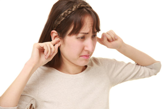 Young woman suffers from noise