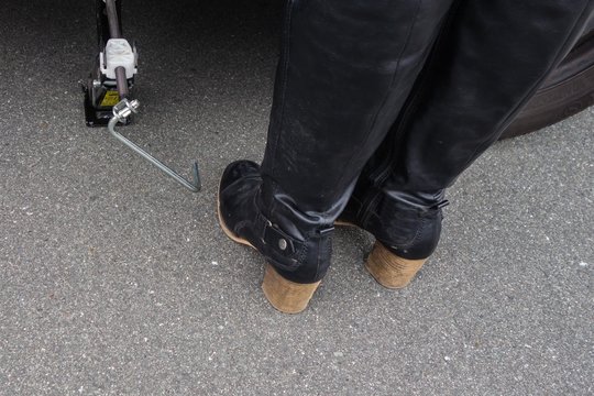 Wagenheber und Frauenstiefel