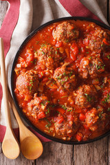 Tasty food: Meatballs albondigas with tomato sauce close-up. vertical top view
