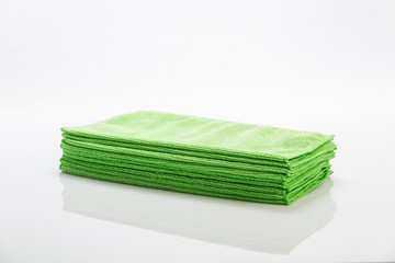 Green cleaning clothes isolated on white