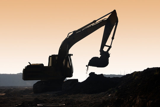 excavator digging, silhouette
