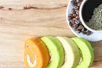 soft focus in  black coffee in White cup with 
blur cake Roll background