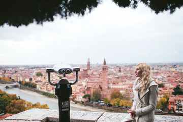 girl sitting on the viewpoint with views of Verona