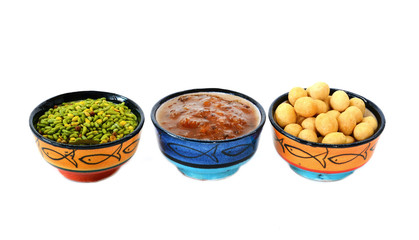 Various delicious ingredients for breakfast. Jam, nuts. Isolated on white background