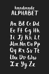 Fototapeta na wymiar Handwritten calligraphic white alphabet written with brush pen on black background. Handmade ABC font typography