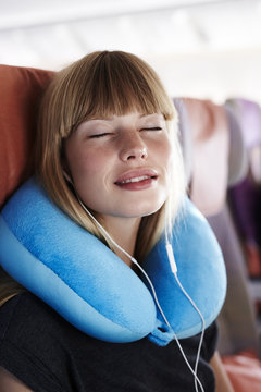 Beautiful passenger sleeping on plane