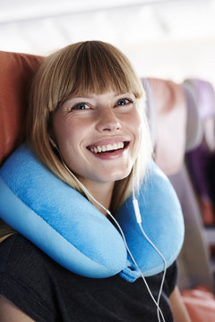 Excited young passenger on plane, smiling