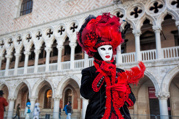 Fototapeta na wymiar Carnival mask against Doge palace in Venice, Italy