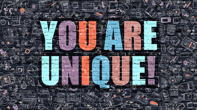 You Are Unique. Multicolor Inscription On Dark Brick Wall With Doodle Icons. You Are Unique Concept In Modern Style. Doodle Design Icons. You Are Unique On Dark Brickwall Background.