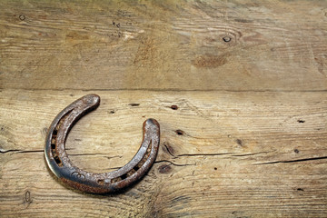 lucky horseshoe on rustic wooden planks, symbol for good luck, background