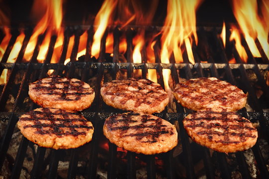 Beef Burgers On The Hot Flaming BBQ Charcoal Grill