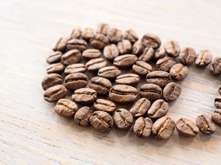 Roasted coffee crop on wooden, background texture
