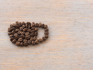 Roasted coffee crop on wooden, background texture