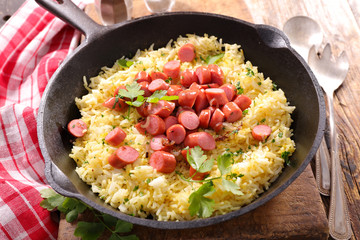 rice and sausage in pan