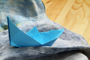 dream about a holiday by the sea/paper boat floating on the waves of denim shorts