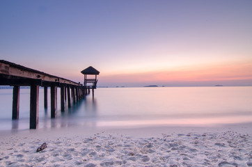 wooden landing with pavilion in the sea.