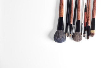 makeup brush and cosmetics, on a color background