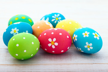 Easter eggs. Colorful Easter eggs on white wooden desk selective focus. Top view, horizontal.